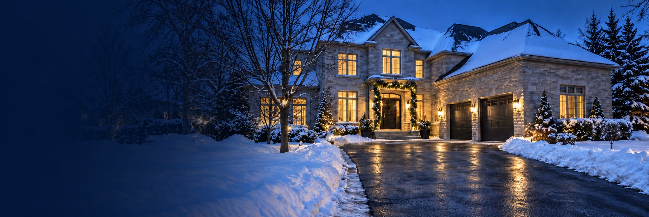 Snow-covered home with a freshly cleared driveway